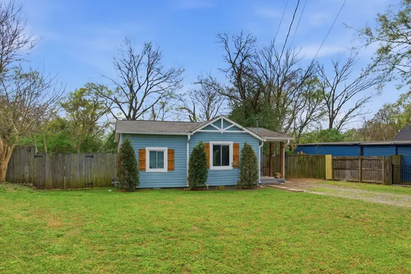 a front view of house with yard and green space