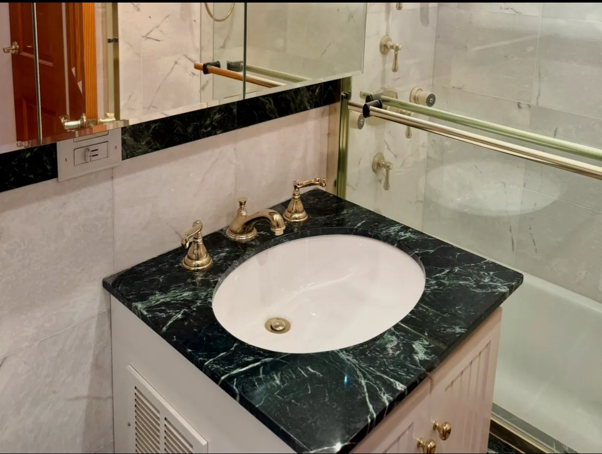 a front view of a building with streets and trees