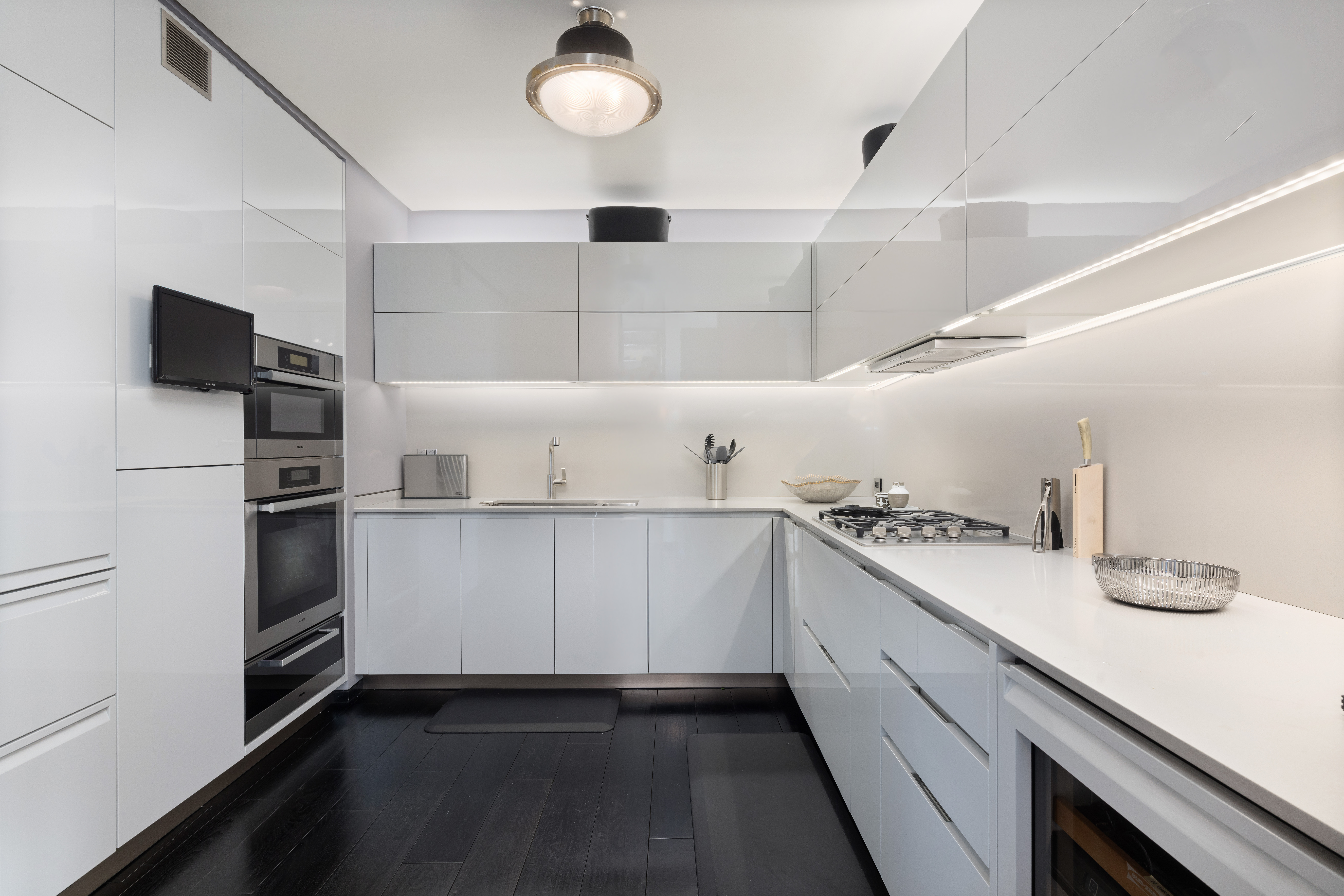 279 Central Park West, Unit 8BC Manhattan, NY 10024 - Photo 9 of 20 a kitchen with white cabinets and appliances