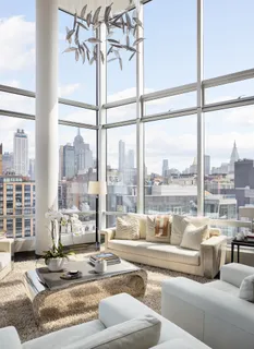 a living room with furniture and a floor to ceiling window