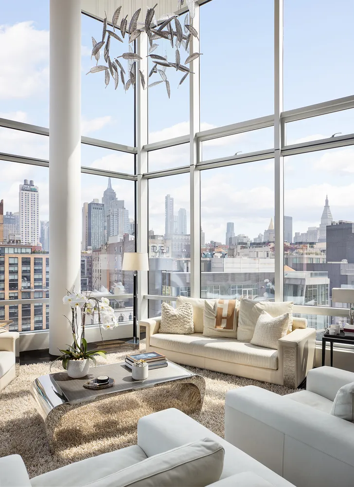 a living room with furniture and a floor to ceiling window