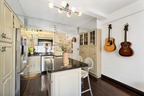 a kitchen with stainless steel appliances granite countertop a sink and refrigerator