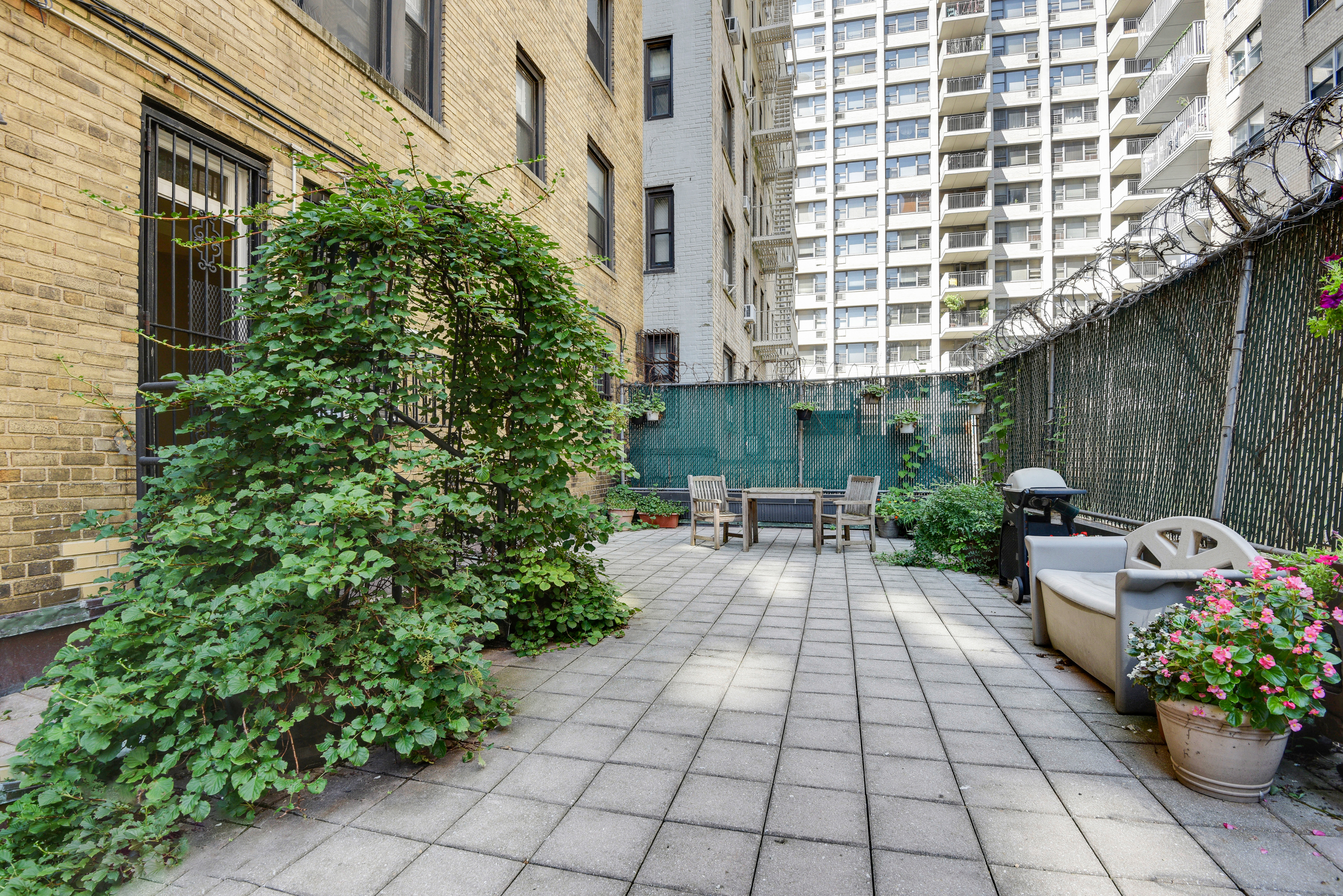 41 West 96th Street, Unit 1B Manhattan, NY 10025 - Photo 9 of 24 a view of a patio with plants and chairs and potted plants
