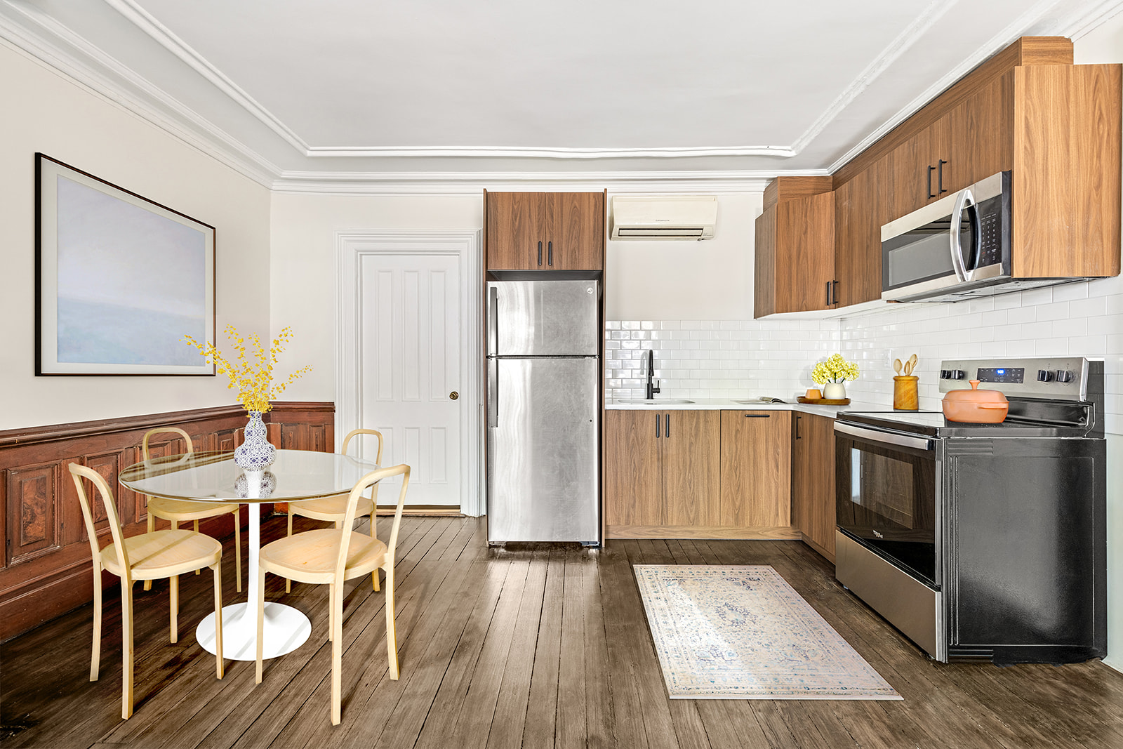 370 Carlton Avenue, Unit GARDEN Brooklyn, NY 11238 - Photo 2 of 7 a kitchen with stainless steel appliances granite countertop a refrigerator a stove top oven a dining table and chairs with wooden floor