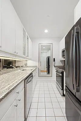 845 United Nations Plaza, Unit 56E Manhattan, NY 10017 - Photo 11 of 28 a kitchen with stainless steel appliances granite countertop a refrigerator and a stove