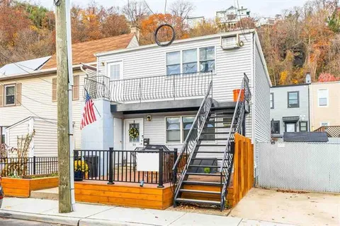 a view of a house with wooden floor and fence