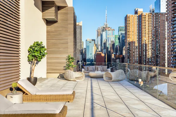 a view of balcony with seating space and city view