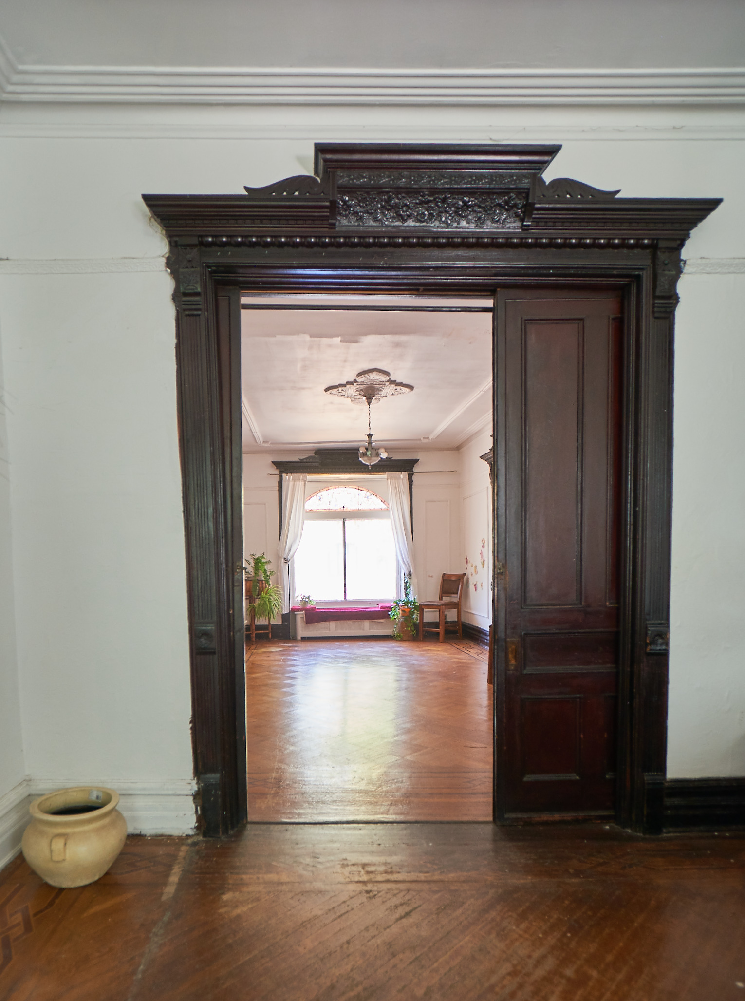 660 Macon Street Brooklyn, NY 11233 - Photo 7 of 17 a view of a hallway with wooden floor and a cabinet