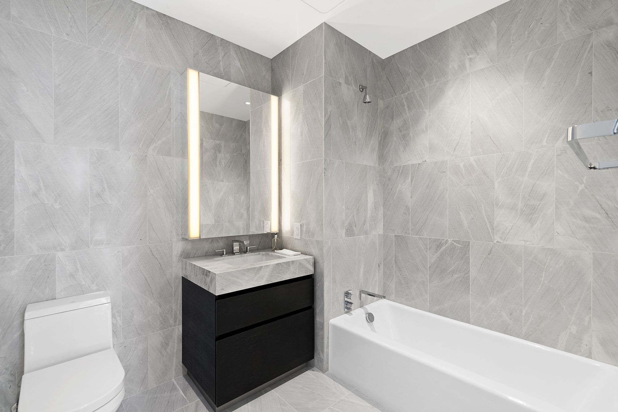 15 Hudson Yards, Unit 66F Manhattan, NY 10001 - Photo 7 of 23 a bathroom with a sink a toilet and bathtub
