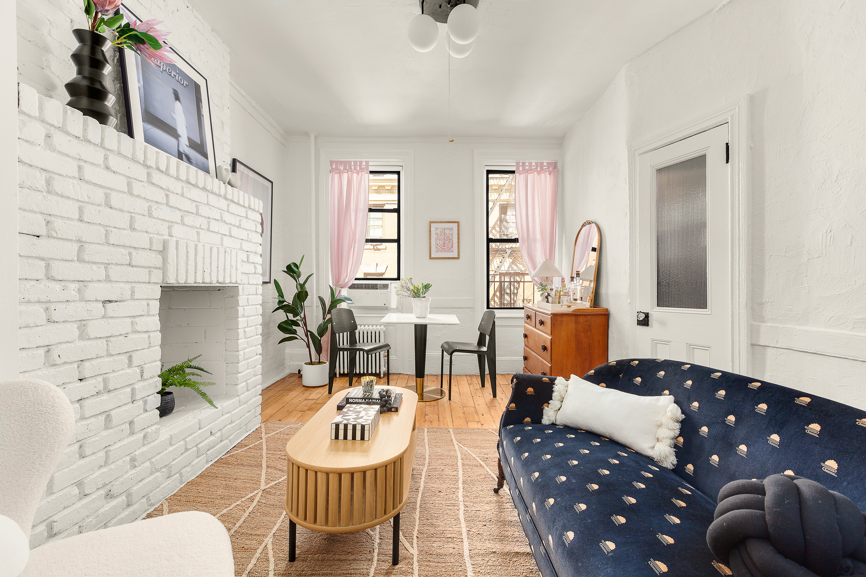 24 Cornelia Street, Unit 15 Manhattan, NY 10014 - Photo 2 of 13 a living room with furniture and a fireplace