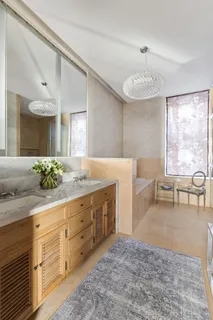 a spacious bathroom with a double vanity sink and a mirror