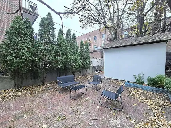 a view of a house with a tree and wooden fence