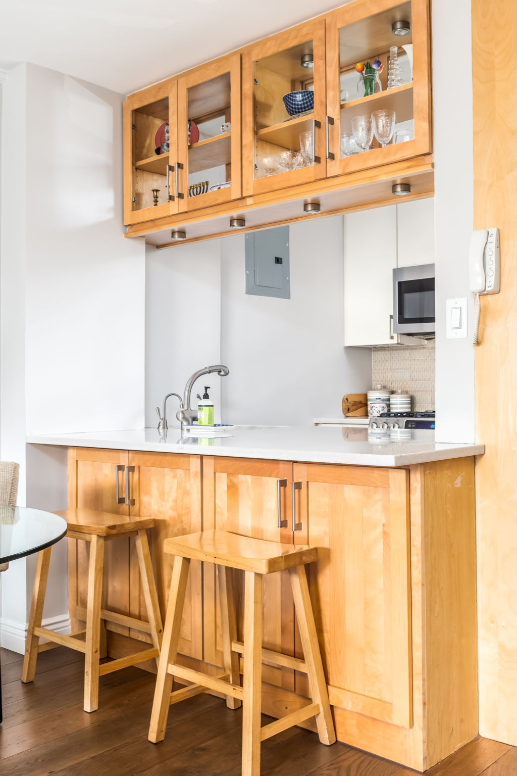 415 East 85th Street, Unit 5J Manhattan, NY 10028 - Photo 7 of 19 a white kitchen with a sink and a wooden floor