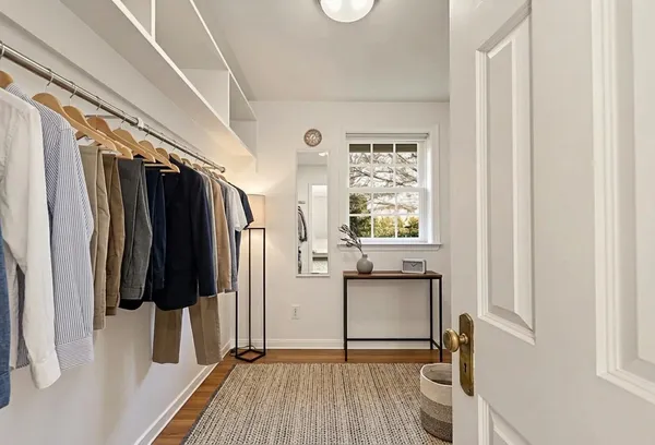 a view of an empty room with wooden floor and entryway