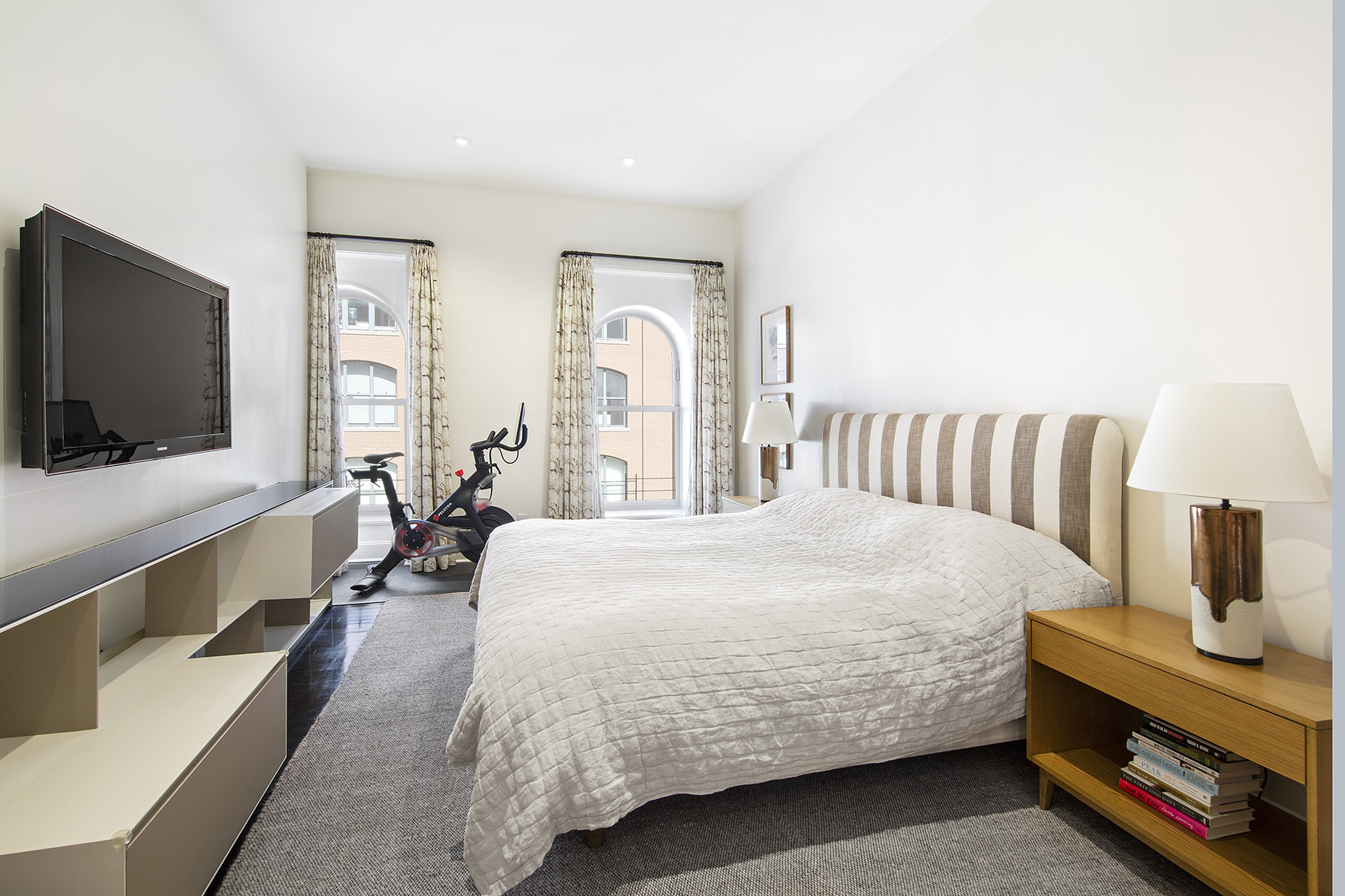 92 Laight Street, Unit 5I Manhattan, NY 10013 - Photo 5 of 12 a bedroom with a bed and a flat screen tv