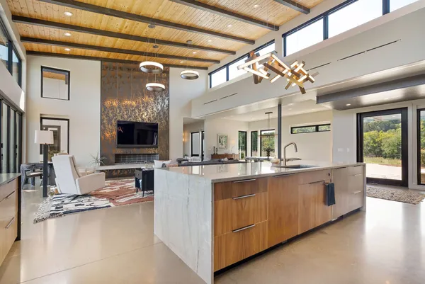 a large kitchen with stainless steel appliances granite countertop a lot of counter space