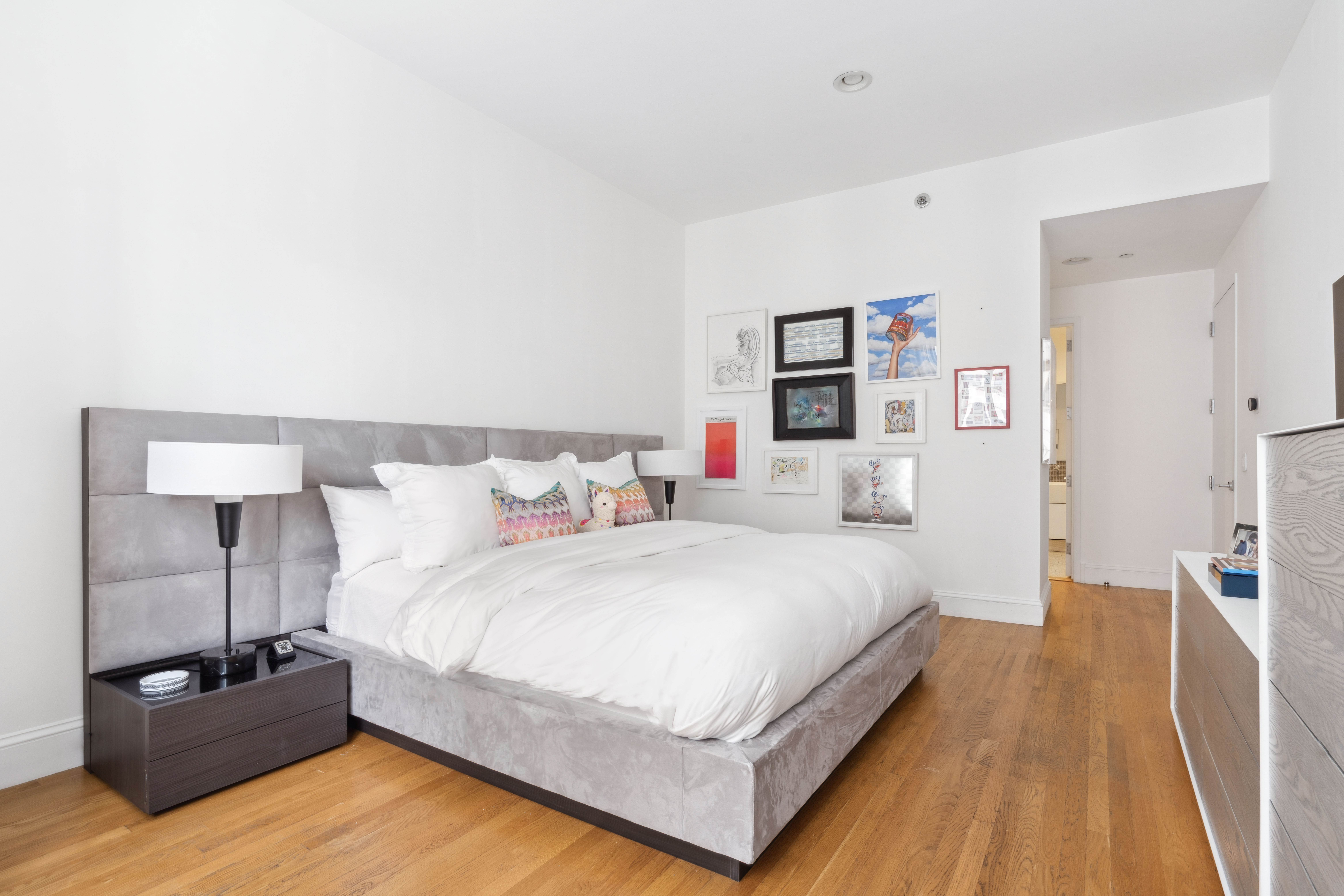 129 Lafayette Street, Unit 3B Manhattan, NY 10013 - Photo 9 of 13 a large bed sitting in a bedroom and a table