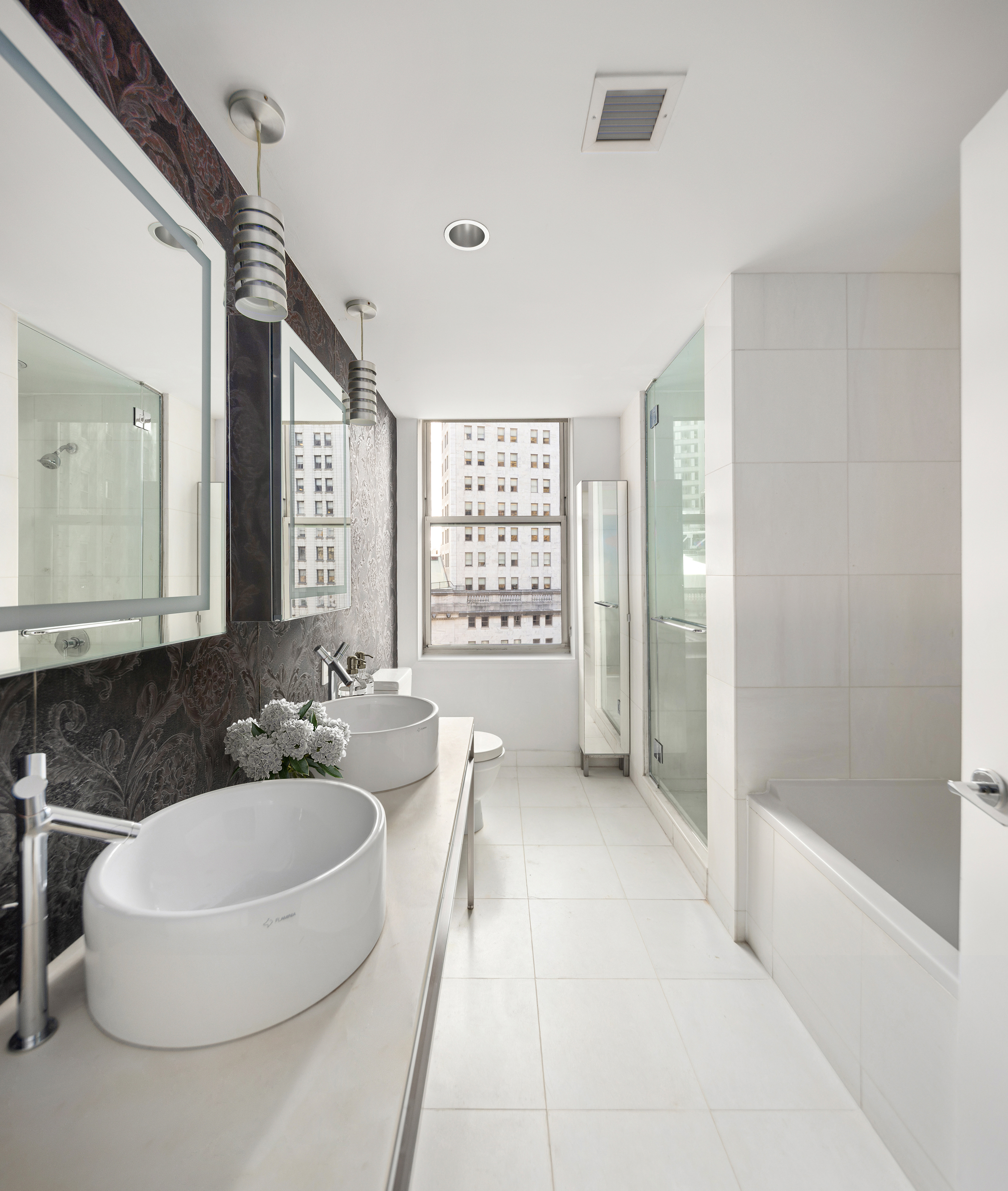 15 Broad Street, Unit 1100 Manhattan, NY 10005 - Photo 5 of 23 a spacious bathroom with a bathtub shower and sink