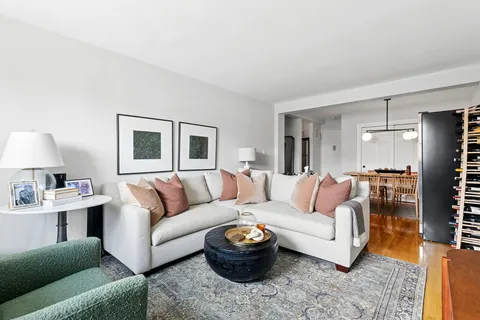 a living room with furniture a lamp and a window