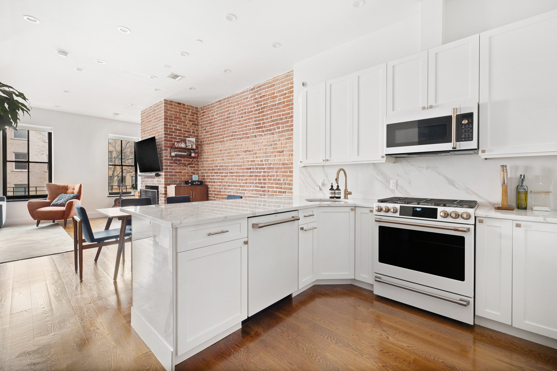 a kitchen with stainless steel appliances white cabinets and a stove top oven