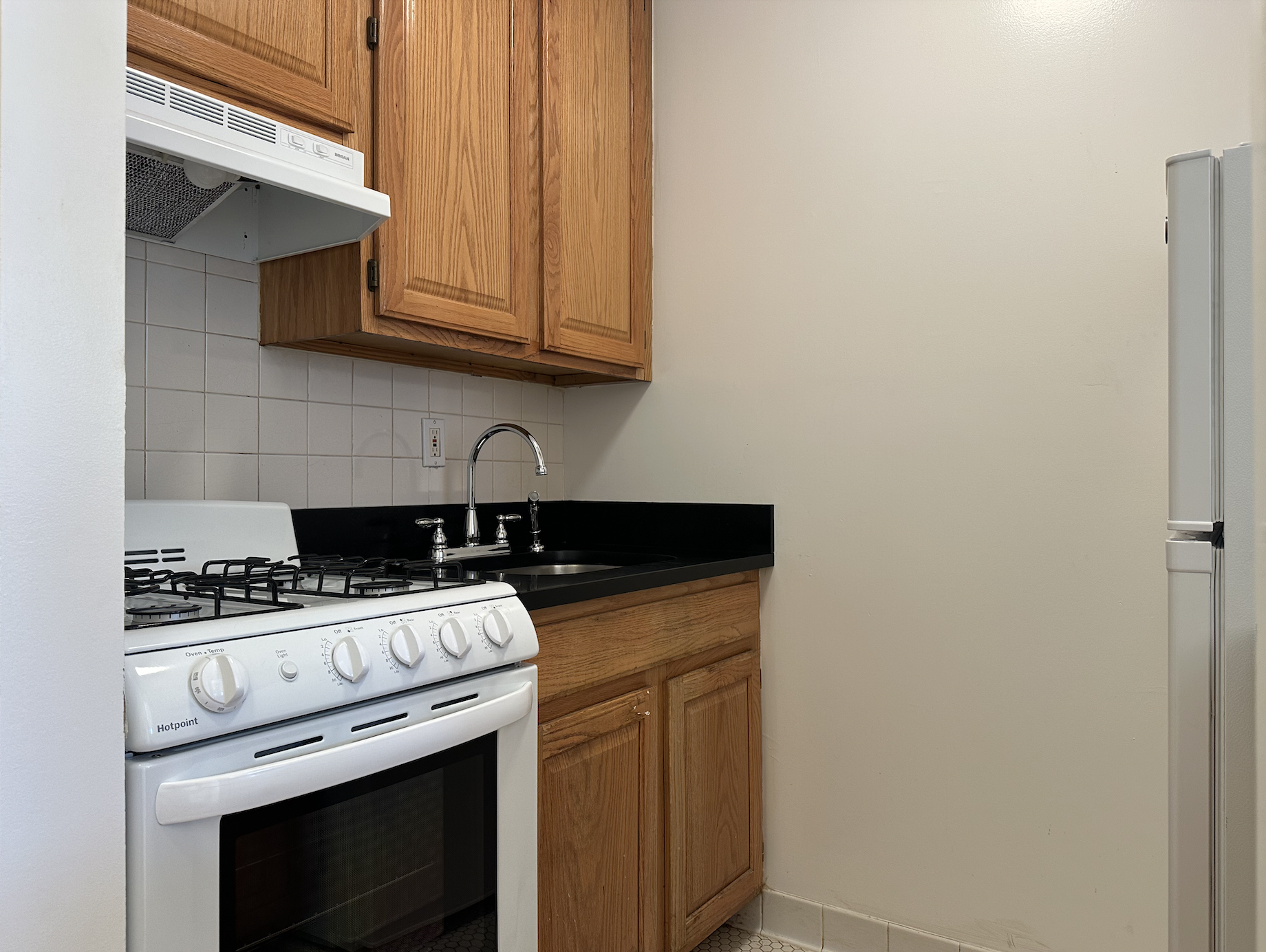 403 West 40th Street, Unit 2FE Manhattan, NY 10018 - Photo 8 of 12 a stove top oven sitting inside of a kitchen