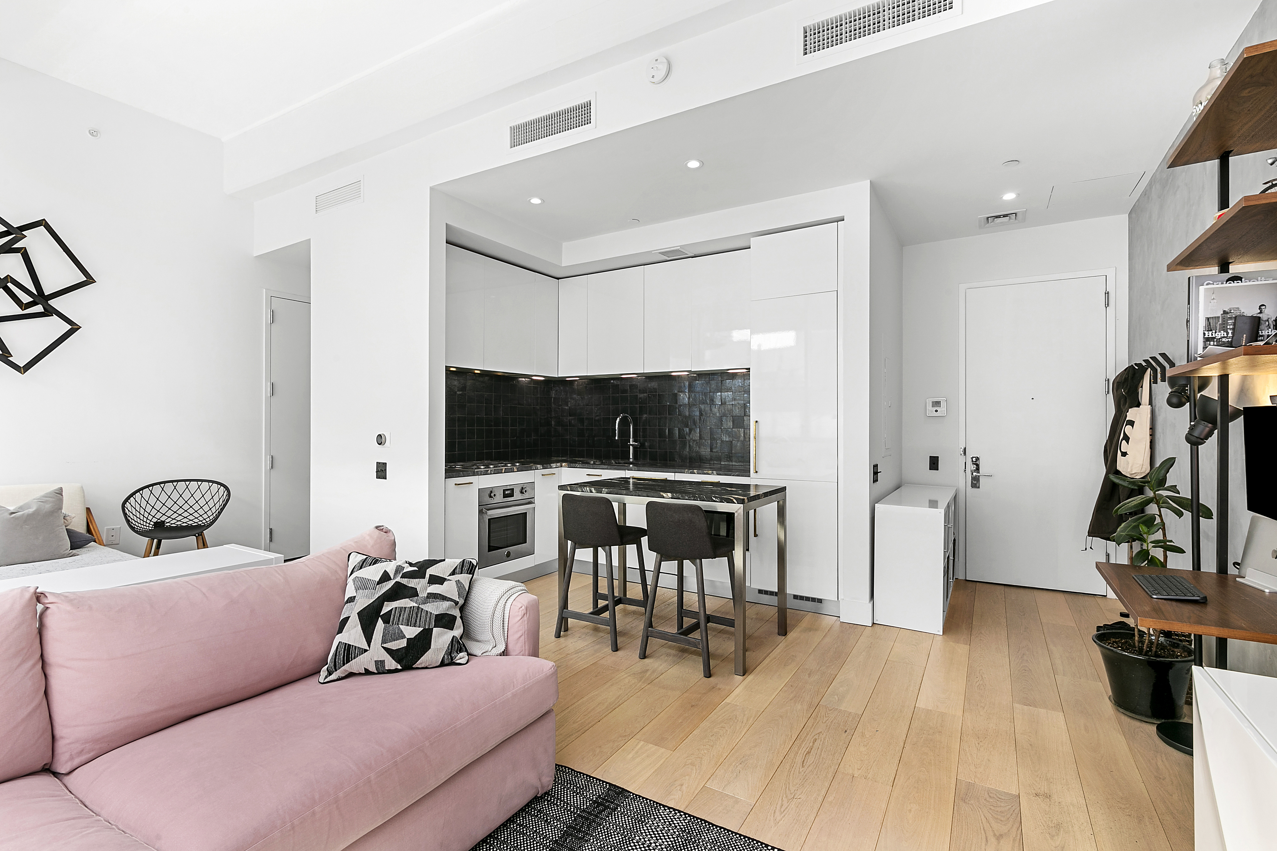 338 Berry Street, Unit 1B Brooklyn, NY 11249 - Photo 3 of 13 a living room with furniture and a flat screen tv