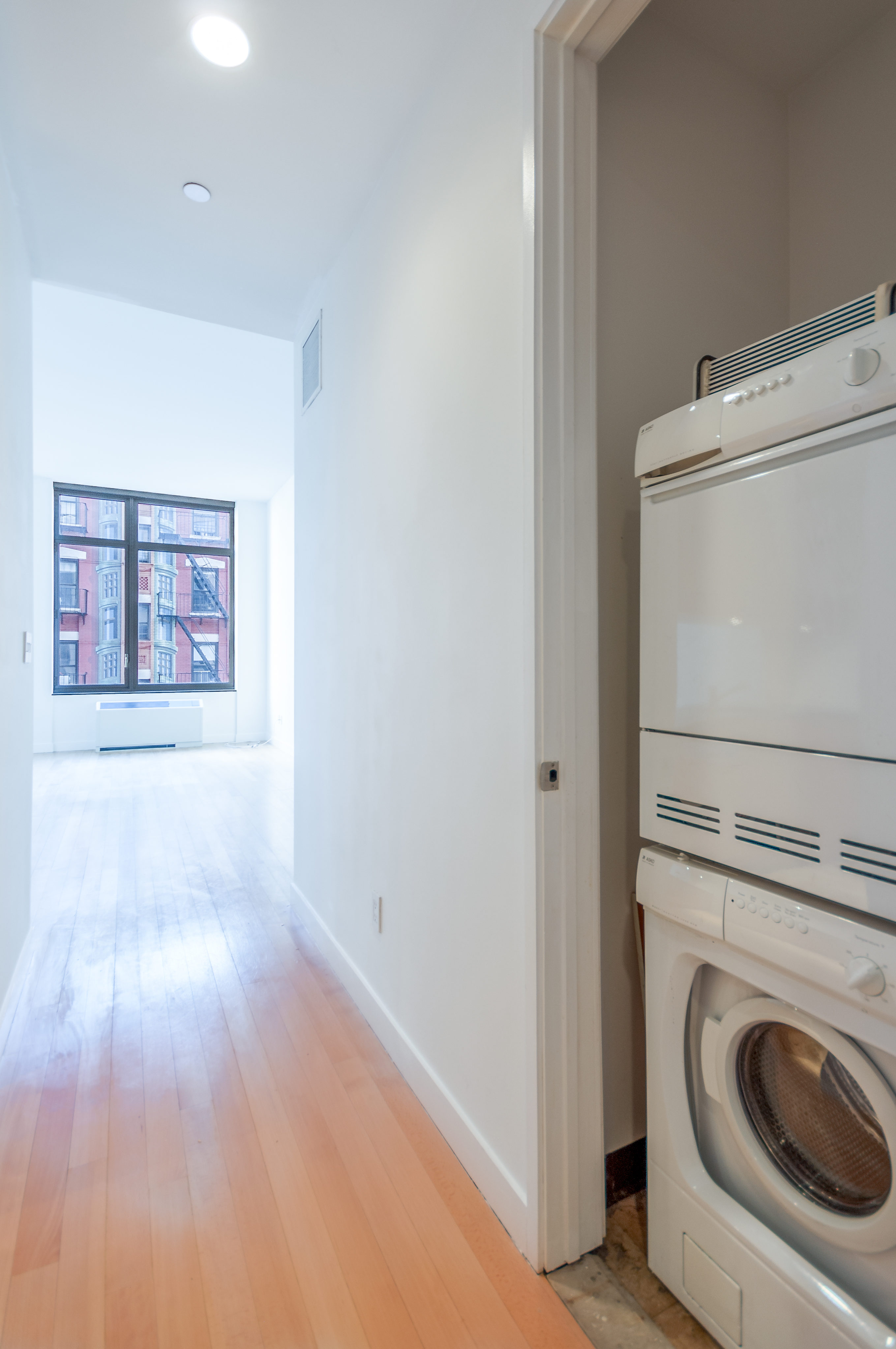450 East 83rd Street, Unit 3D Manhattan, NY 10028 - Photo 9 of 15 a view of a hallway with washer and dryer