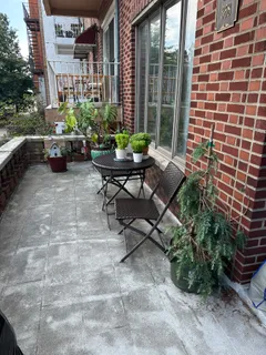 a view of a patio with couches and potted plants