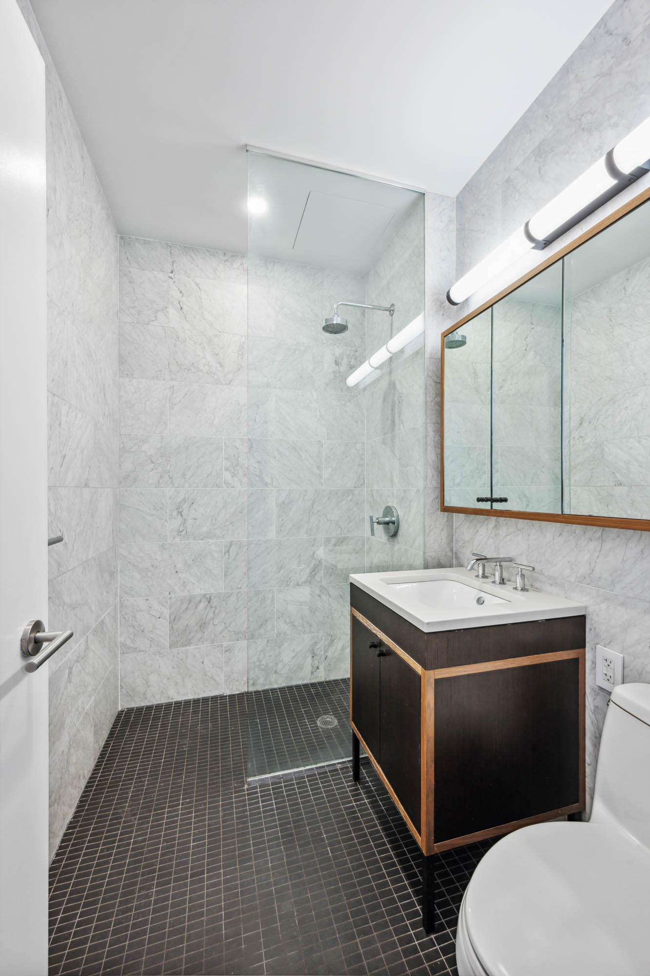 184 Kent Avenue, Unit D512 Brooklyn, NY 11249 - Photo 5 of 11 a bathroom with a sink toilet and mirror