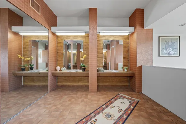a bathroom with a tub shower and toilet