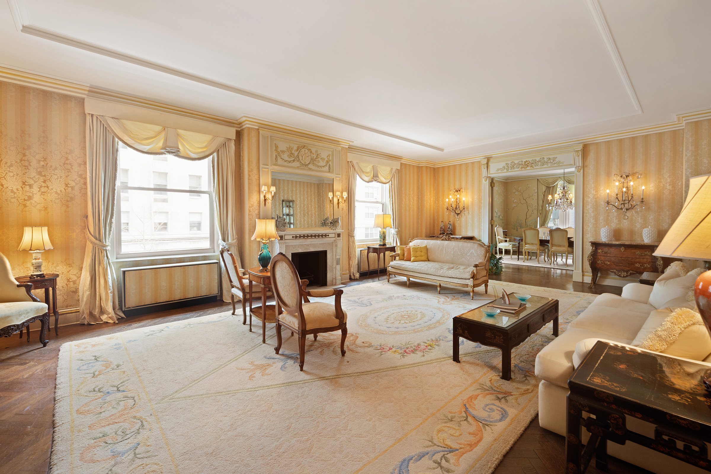 31 East 72nd Street, Unit 4B Manhattan, NY 10021 - Photo 1 of 14 a living room with furniture a fireplace and large windows