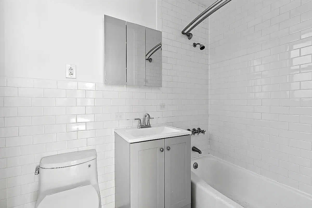 643 9th Avenue, Unit 5A Manhattan, NY 10036 - Photo 5 of 6 a bathroom with a sink a toilet and shower