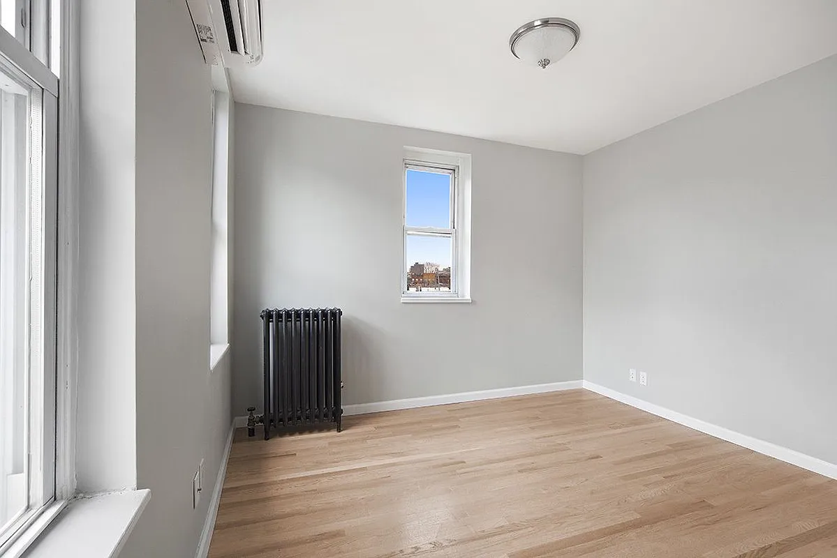 306 7th Street, Unit 1 Brooklyn, NY 11215 - Photo 4 of 9 a view of an empty room with wooden floor and a window