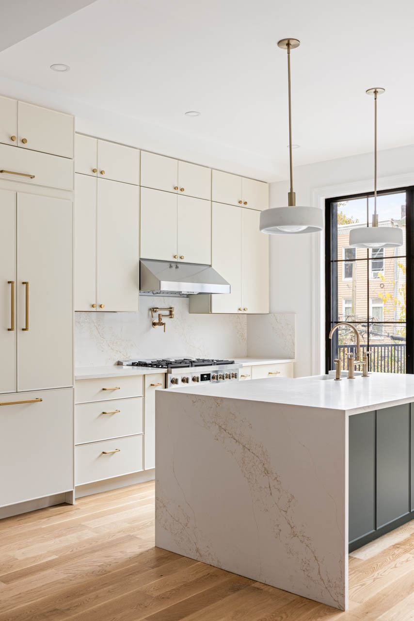 668 Decatur Street Brooklyn, NY 11233 - Photo 4 of 14 a kitchen with stainless steel appliances white cabinets and a wooden floors