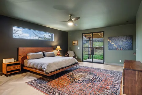 a bedroom with a large bed and a window