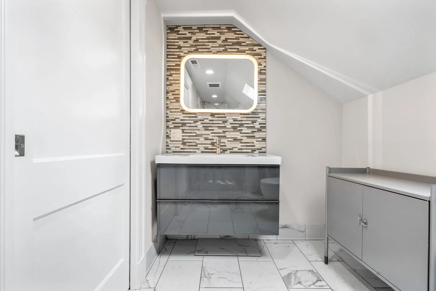 a bathroom with a window and a mirror