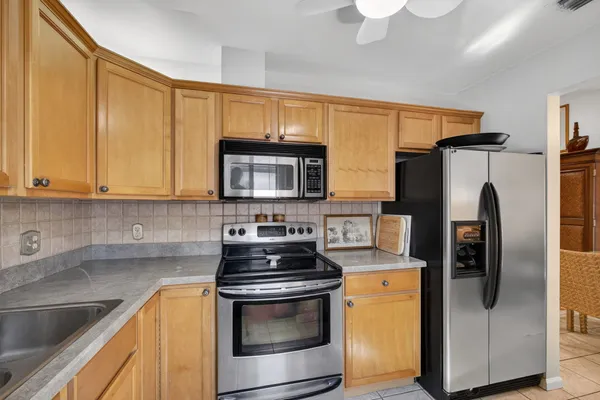 a kitchen with stainless steel appliances a stove a sink and a refrigerator