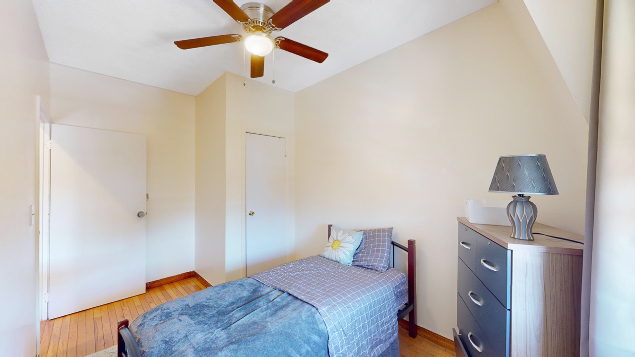 495 Central Avenue, Unit 2 Brooklyn, NY 11221 - Photo 14 of 19 a bedroom with a bed and a chandelier