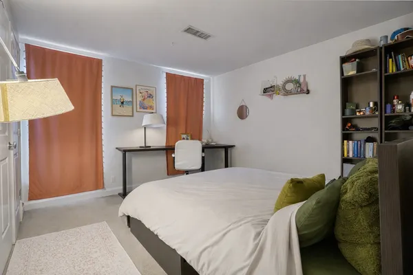 a front view of a multi story building with a yard