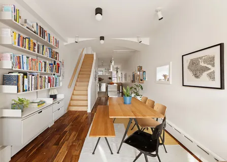 a dining room with furniture and wooden floor