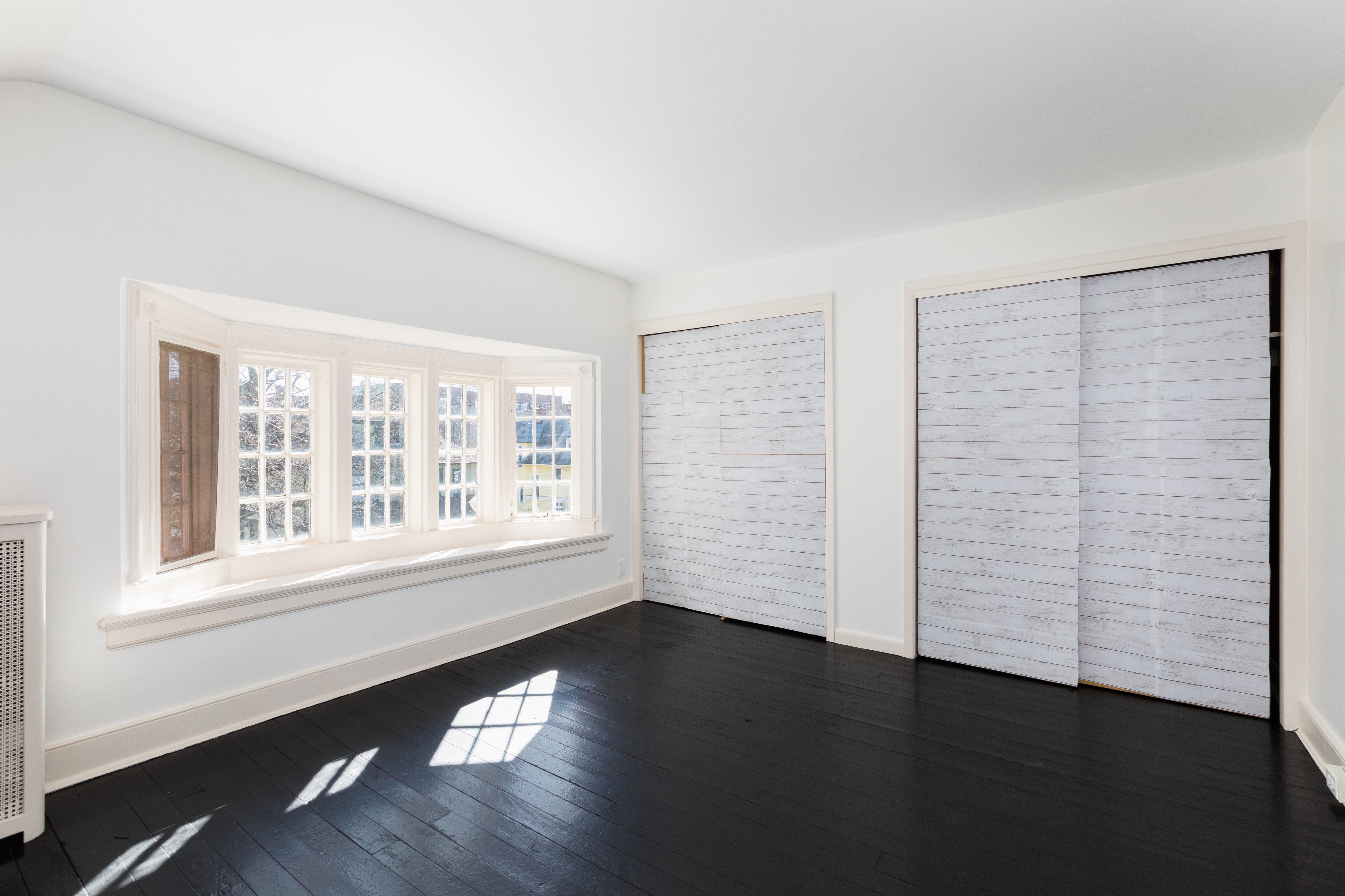 196 Marlborough Road Brooklyn, NY 11226 - Photo 20 of 23 wooden floor in an empty room with a window