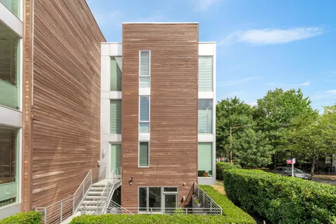 a brick building with a yard in front of it