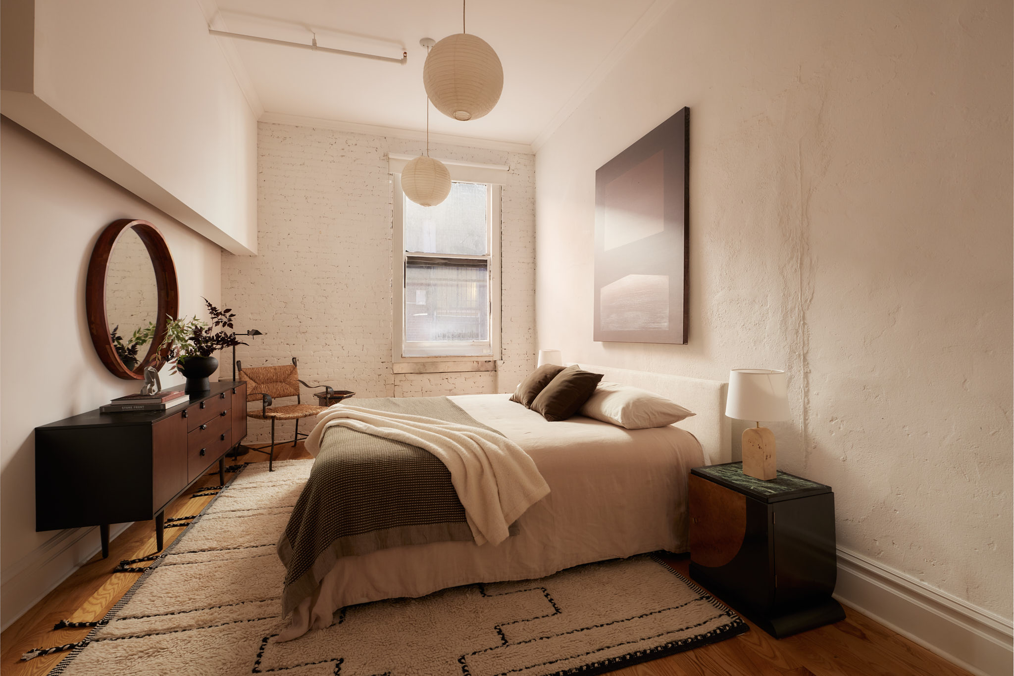 2 Bond Street, Unit 2 Manhattan, NY 10012 - Photo 10 of 16 a bedroom with a bed and a large mirror with a large window