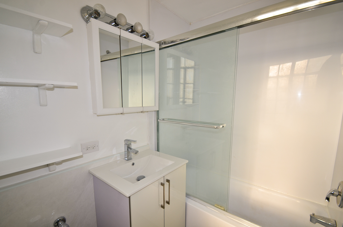 5 Tudor City Place, Unit A15 Manhattan, NY 10017 - Photo 6 of 8 a bathroom with a sink and a shower