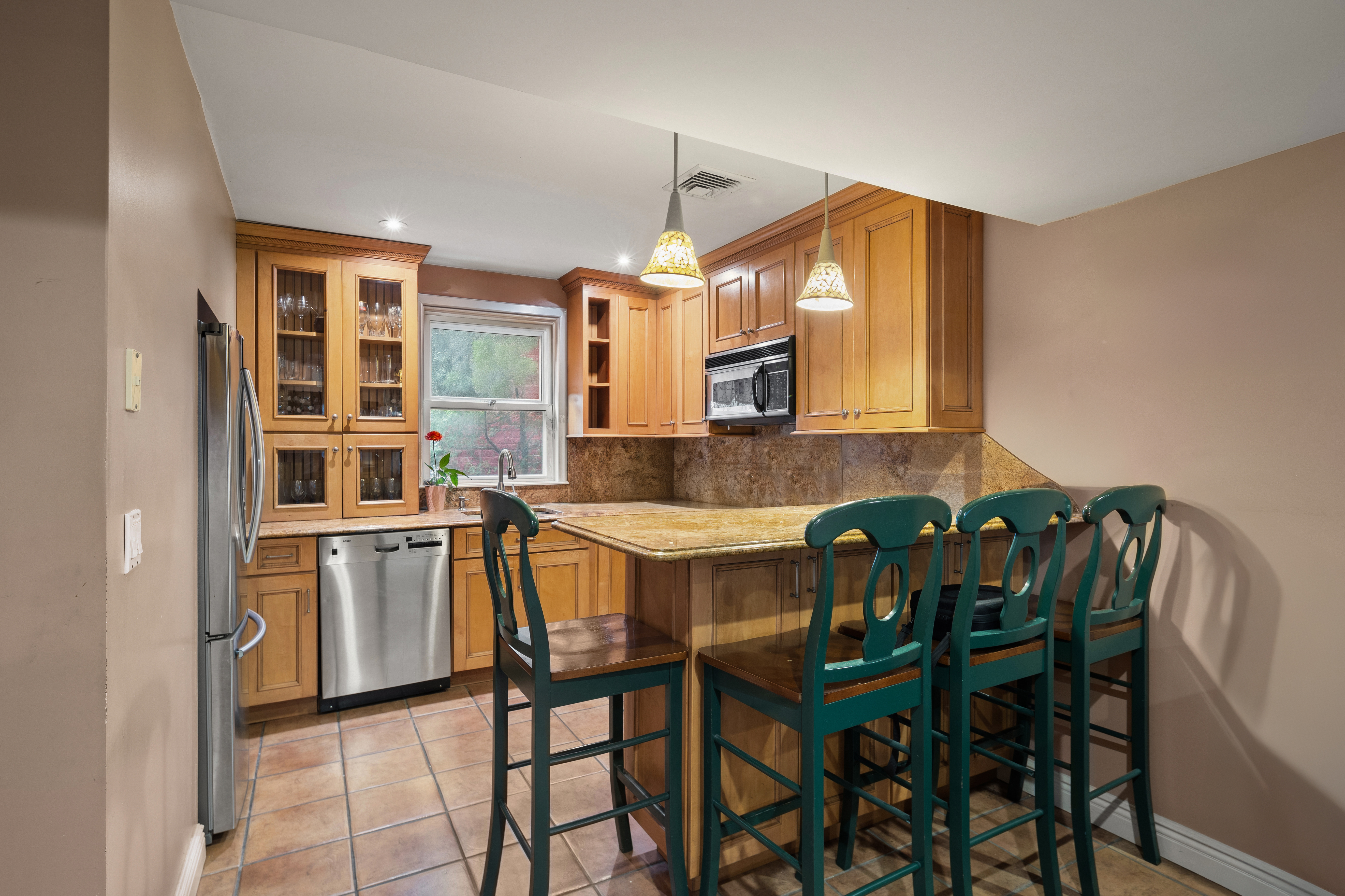 110 82nd Street Brooklyn, NY 11209 - Photo 14 of 28 a kitchen with a table chairs sink and cabinets