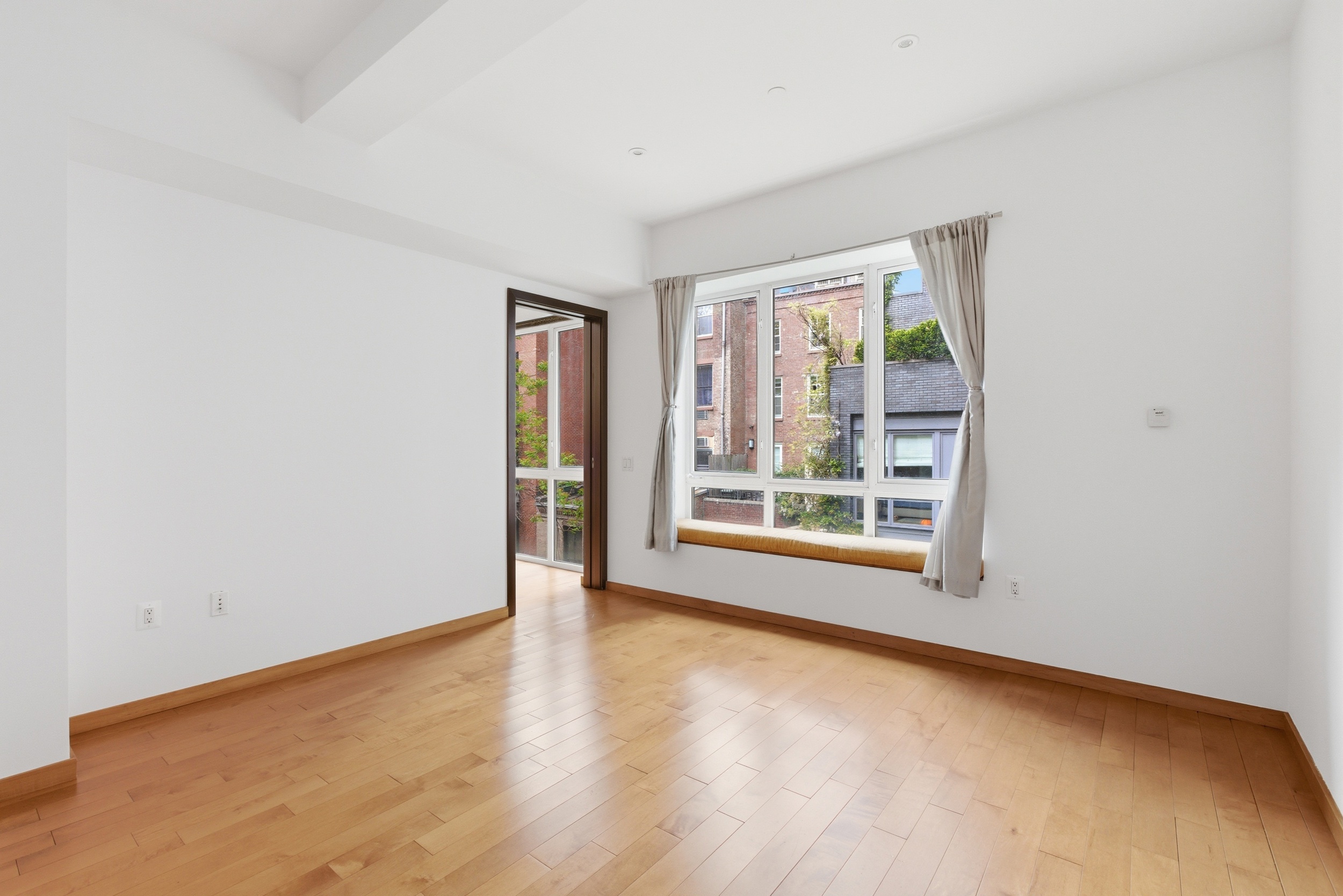 135 West 4th Street, Unit 3W Manhattan, NY 10012 - Photo 15 of 24 a view of an empty room with a window
