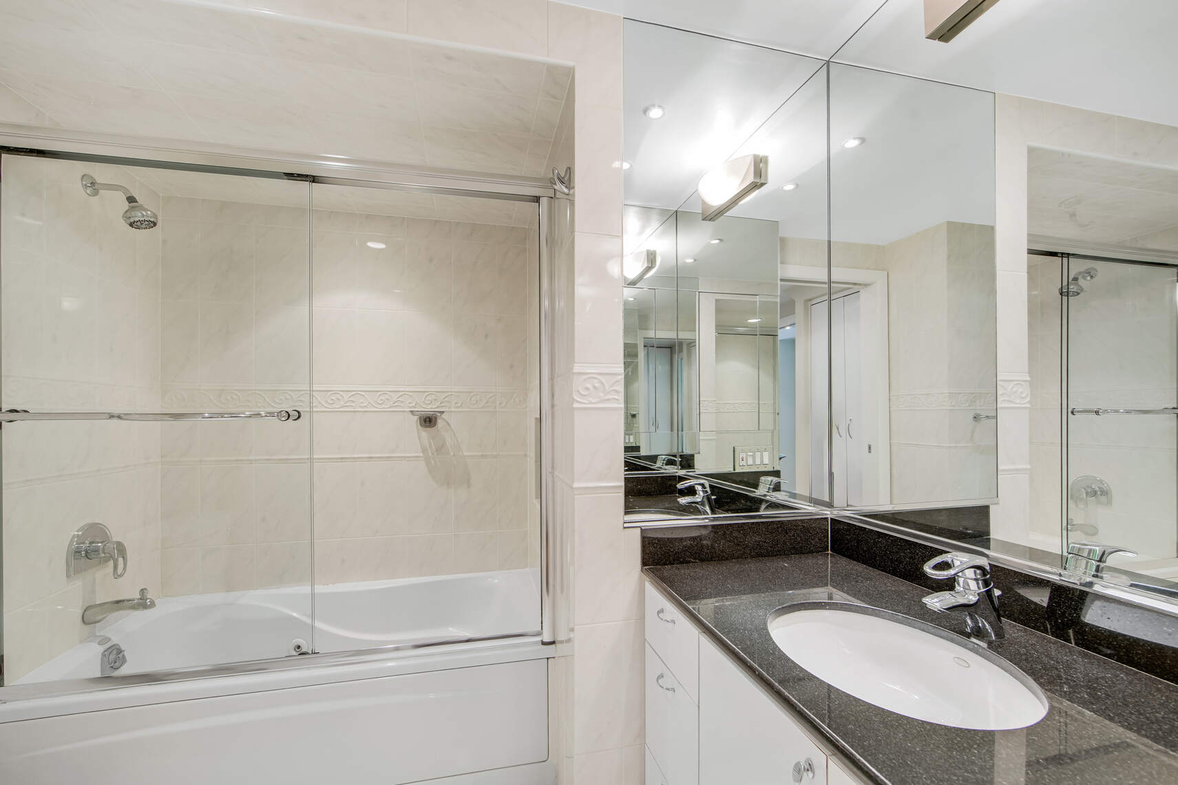 150 West 56th Street, Unit 3812 Manhattan, NY 10019 - Photo 10 of 14 a bathroom with a sink double vanity and a mirror
