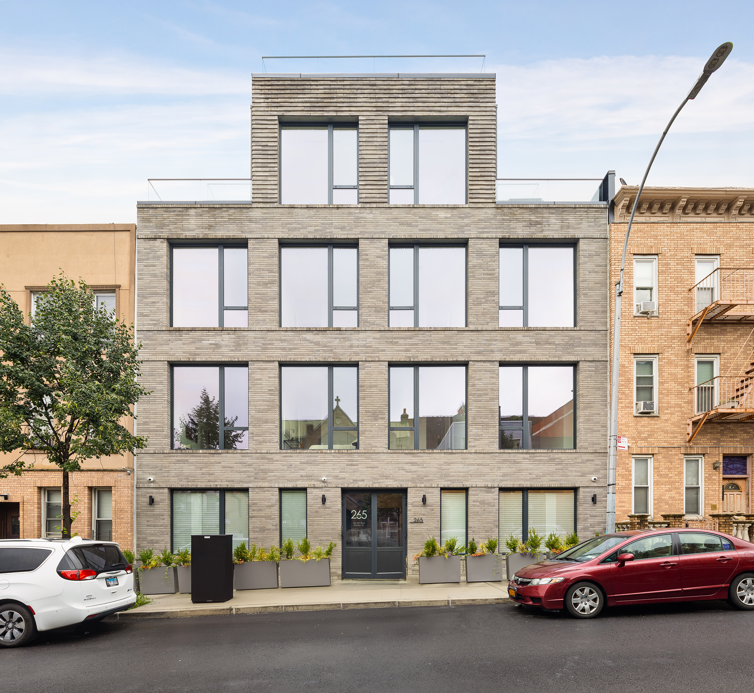 265 20th Street, Unit 3R Brooklyn, NY 11215 - Photo 5 of 6 a couple of cars parked in front of a building