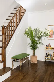a living room with furniture and a potted plant