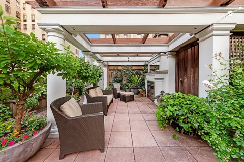 a view of a porch with furniture and garden